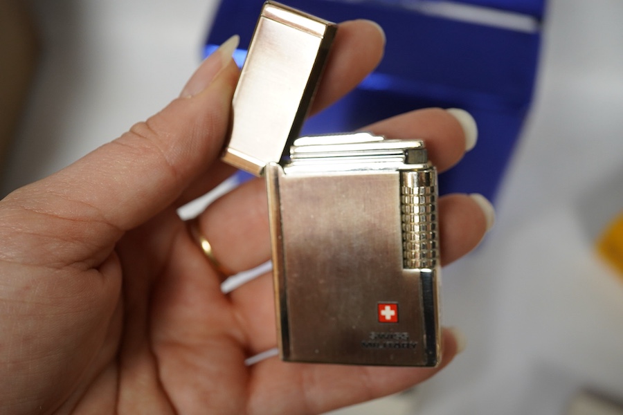 Sundry items comprising, two luxury wallets, boxed, Swiss military lighter and gent's manicure set. Condition - fair